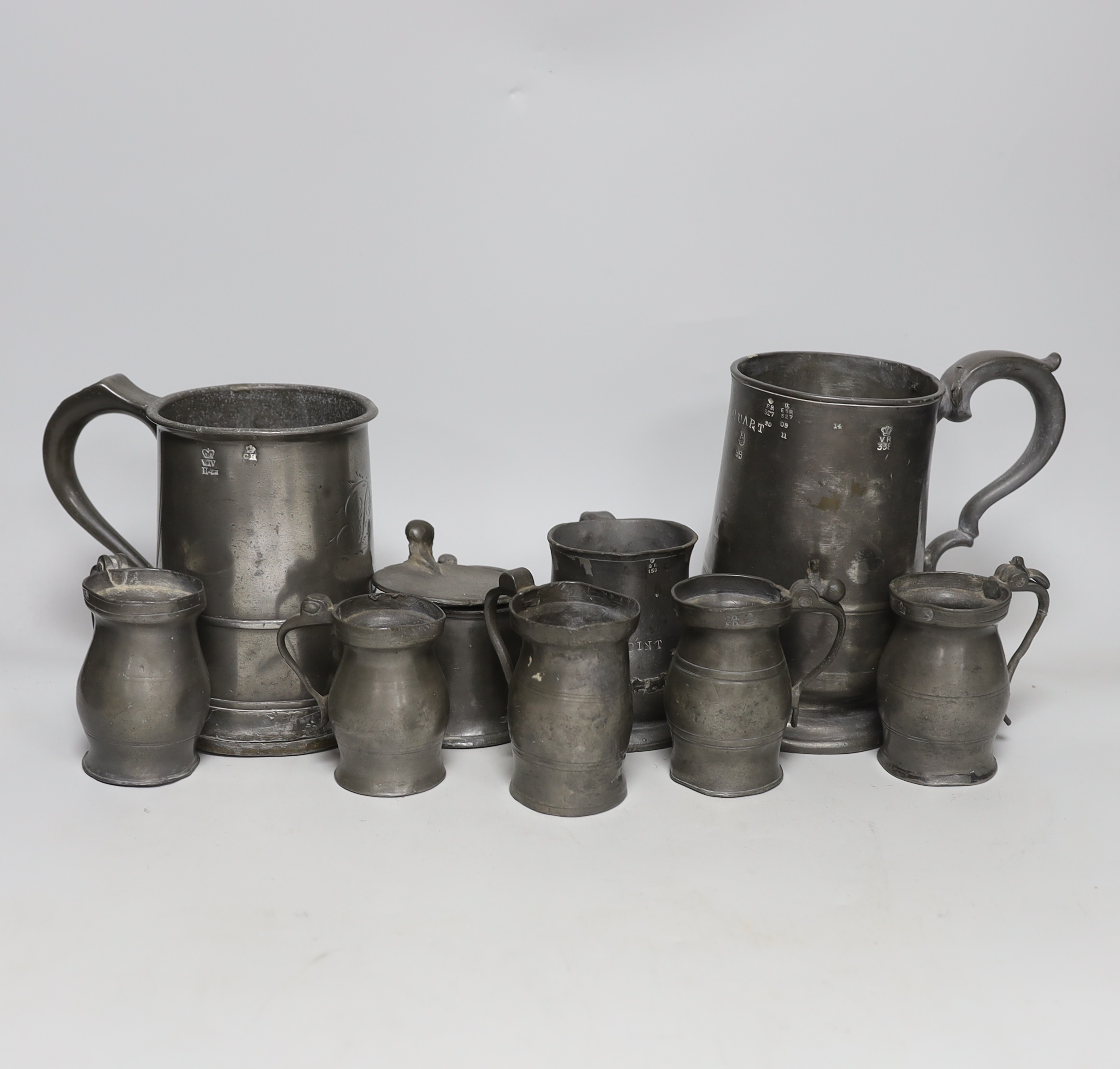 A collection of 19th century pewter ale mugs pewter measures and a mustard pot tallest 16.5 cm high